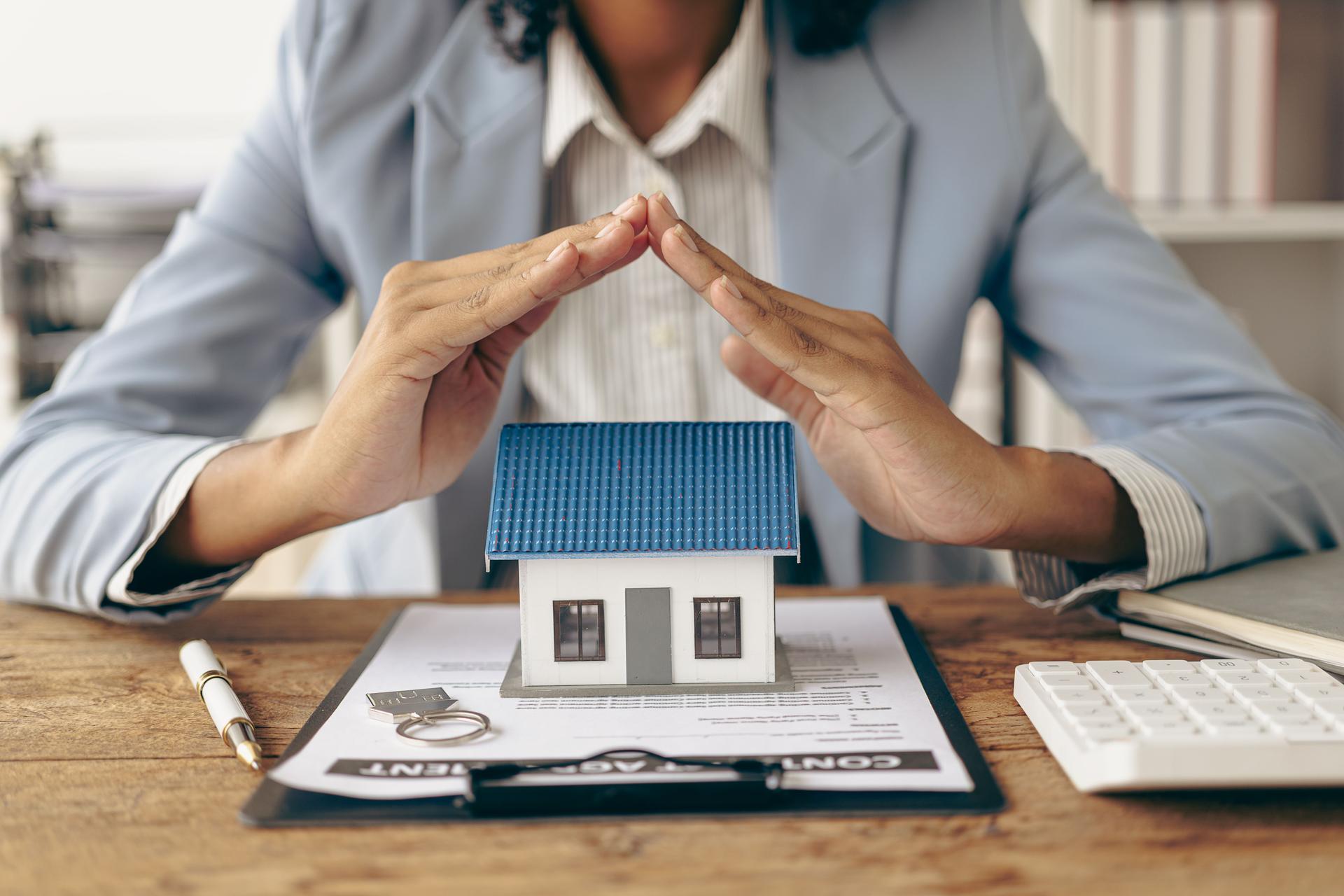 Hands-on protection on small house mortgage loans, property management Investment and Risk Management Family and home insurance man in shirt
