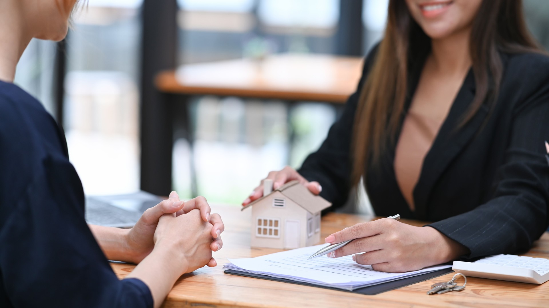 Financial advisor offering home ownership and property insurance to costumer. Real estate investors and sales contracts concept.